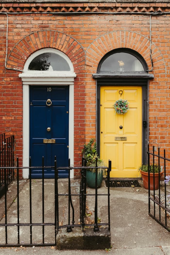 Blue and yellow Georgian front doors on a Dublin brick terrace
