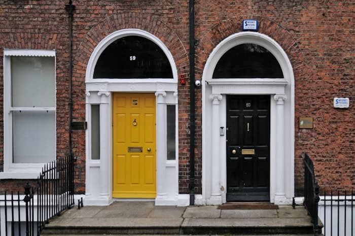 Yellow and black Georgian front doors on a Dublin brick terrace