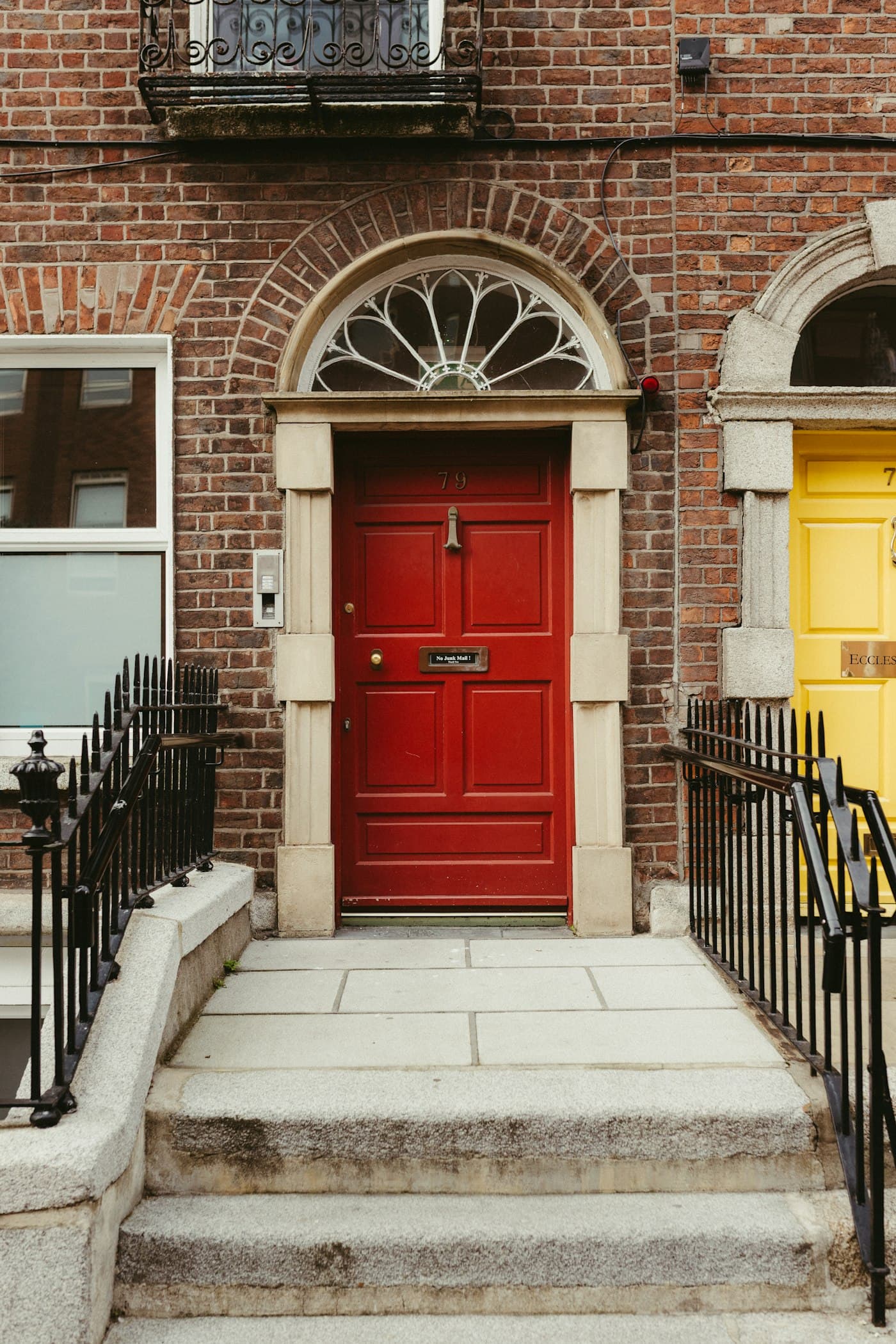 Crimson Georgian doorway with stone steps and a decorative fanlight