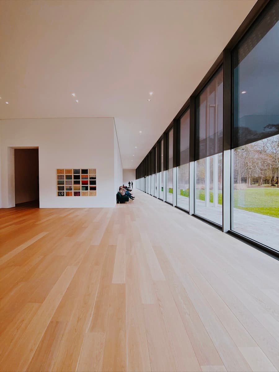Light laminate plank flooring running through a bright room